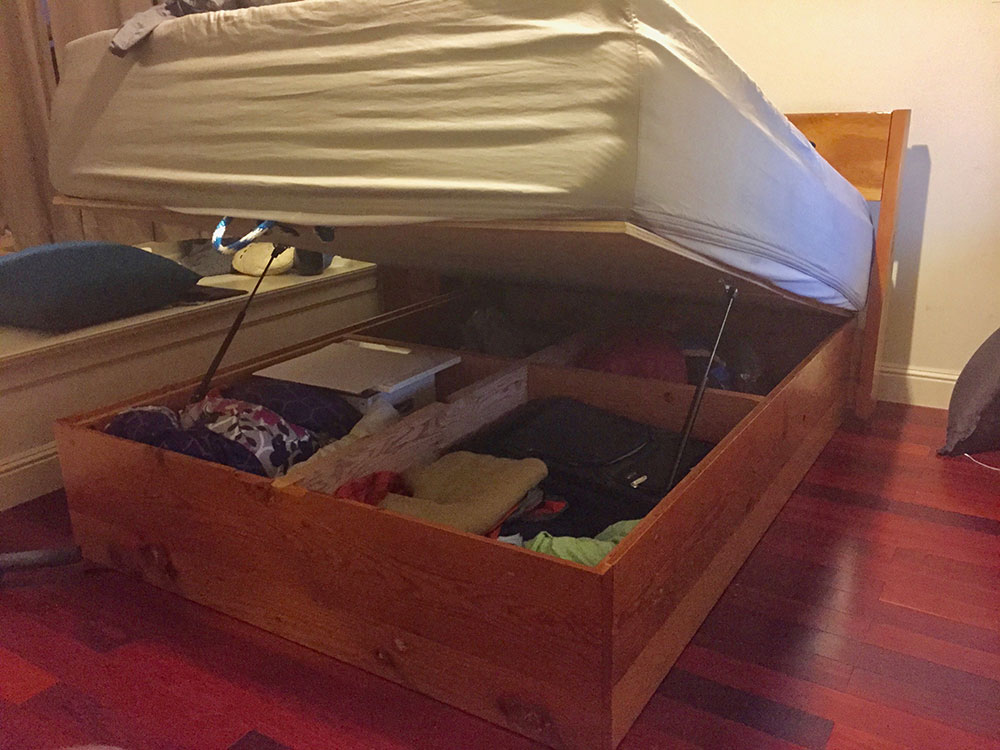 Photo of bed lifted, with storage underneath
